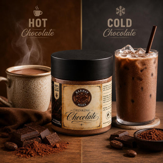 A jar of Barnay Mixes Drinking Chocolate in the center, styled with a steaming mug of hot chocolate on the left and an iced chocolate drink on the right, on a wooden table with chocolate pieces and cocoa powder scattered.